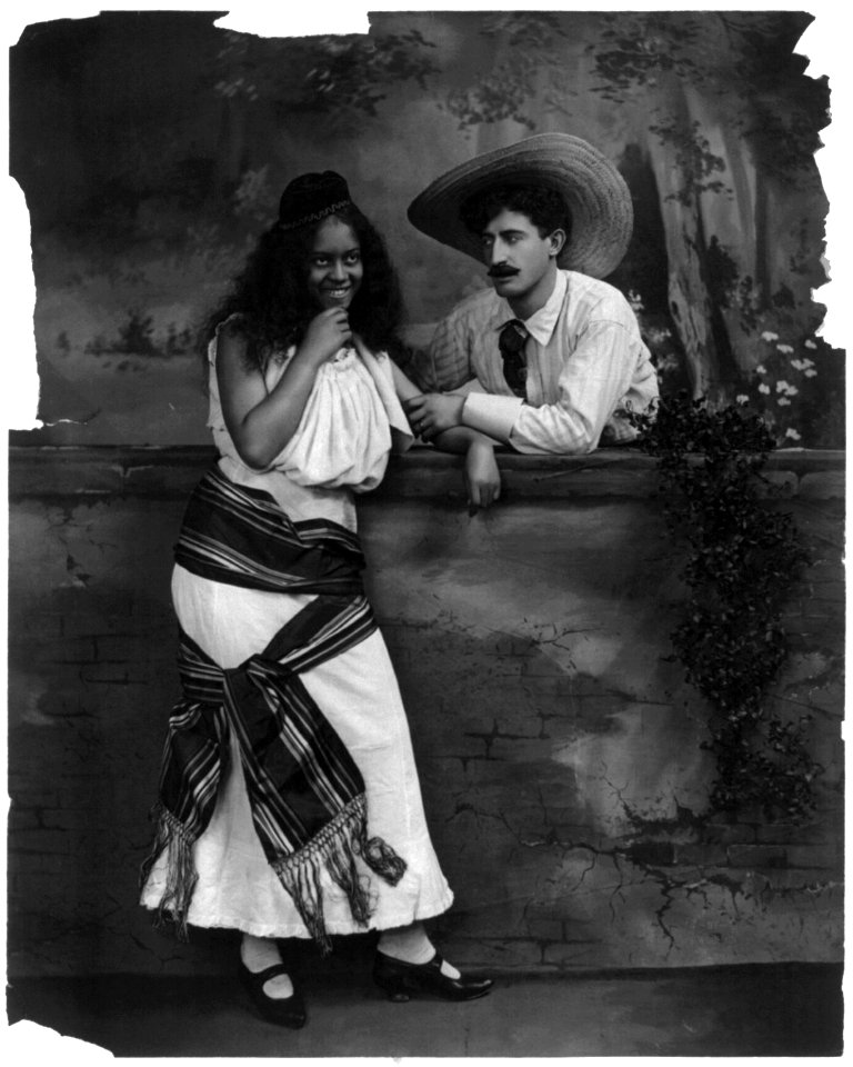 White man holding arm of African American woman LCCN2003675180