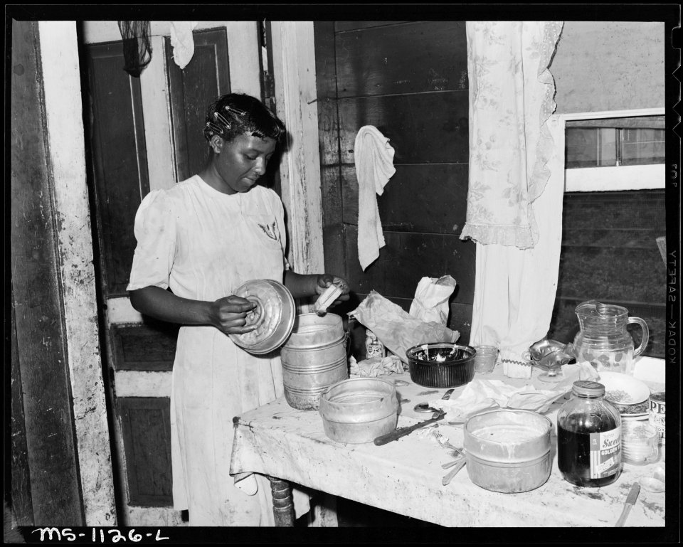 Wife of miner filling lunch bucket. They live in company housing project. Pando Coal Company, Pando ^7 Mine, Mohegan... - NARA - 540678