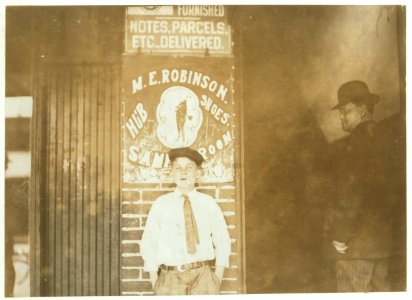 Wilbur Gold, Western Union Messenger -14, twelve years old; works until 11 P.M., usually, but all night when they are busy (See report of L.W.H.) Note sign above his head. LOC nclc.03561