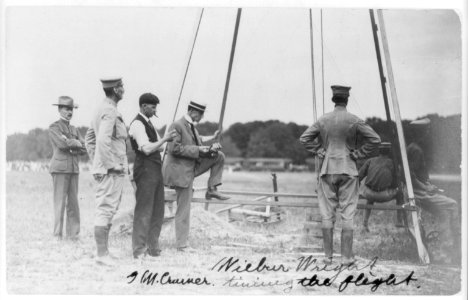 Wilbur Wright and G.M. Cramer timing the flight, surrounded by U.S. Army officers, Fort Myer, Virginia LCCN2005691625