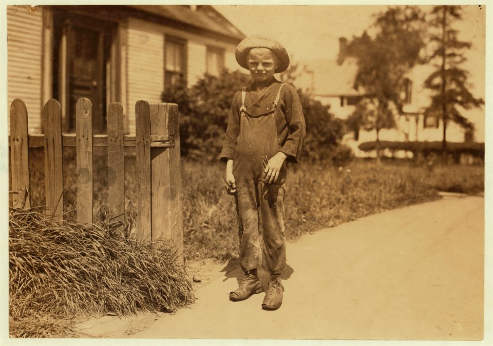 Wilfred Clark, 10 years old, 24 Key St., going home at noon, after cutting five boxes of fish during the morning. Incidently, he cuts his fingers. See left fore-finger. Two other boys with LOC nclc.00952