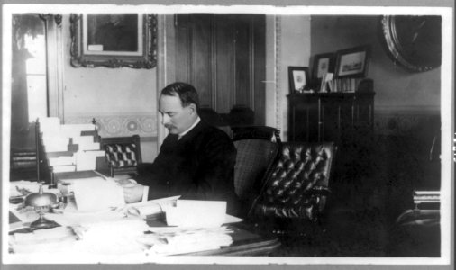 William Collins Whitney, Secretary of the Navy, half-length portrait, seated at desk, facing left LCCN89709672