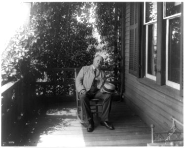William Dean Howells, 1837-1920, full-length portrait, seated, facing right, on porch LCCN2005691570