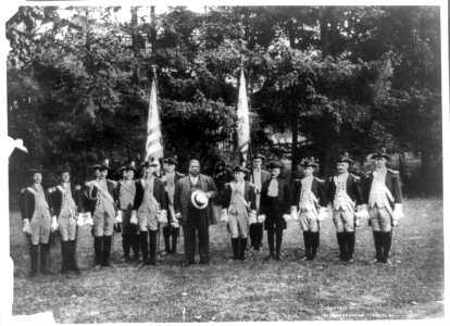 William H. Taft standing outdoors with twelve men in Revolutionary War uniforms LCCN89709594