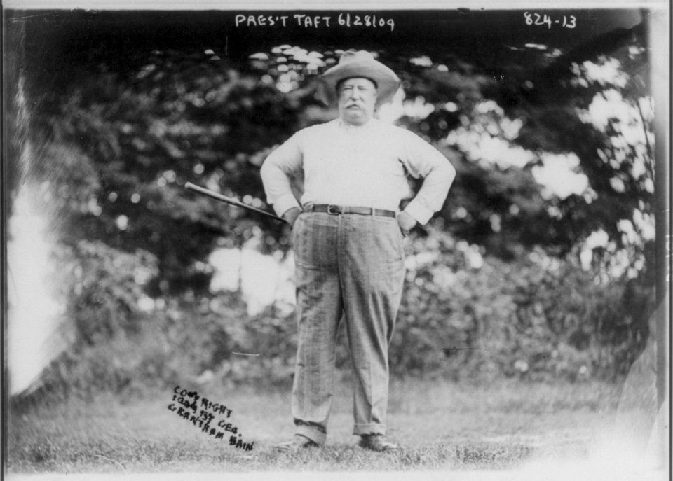 William Howard Taft, 1857-1930, full, standing with arms on hips, holding golf club, facing front LCCN2006682722