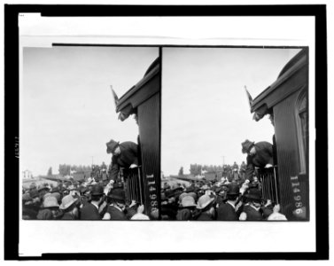 William Howard Taft, standing on back of railroad car and shaking hands, during campaign tour LCCN99400613