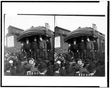 William Howard Taft, standing on back of railroad car and looking out at crowd, probably during campaign tour LCCN91712417