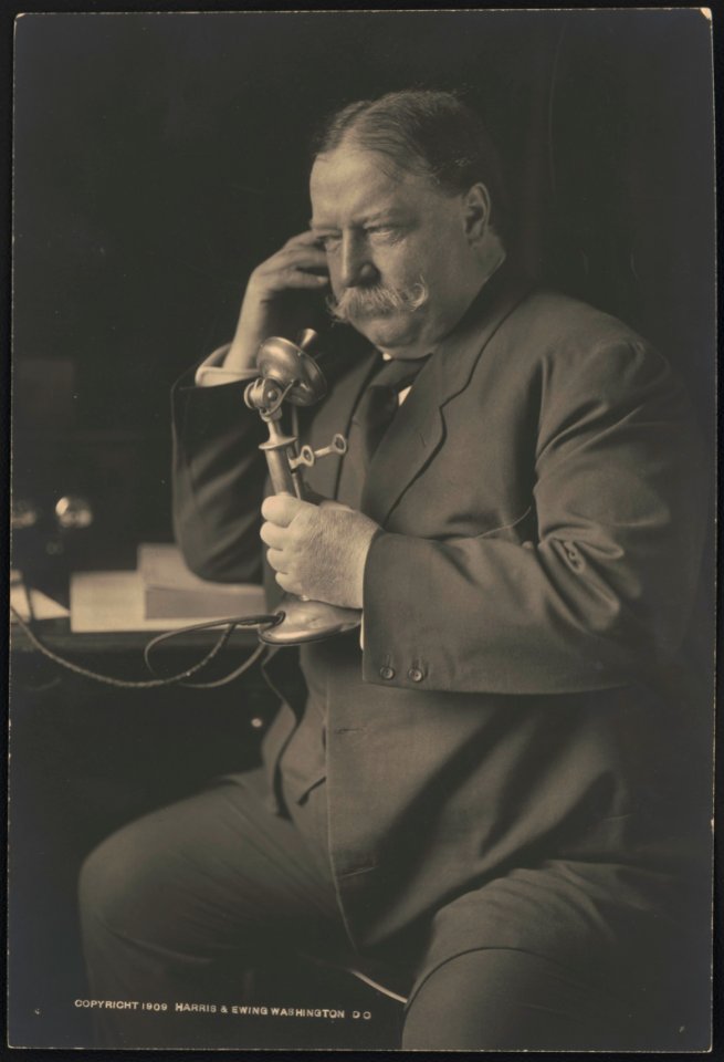 William Howard Taft, three-quarter-length portrait, seated, facing left, talking on a telephone as he receives news about his nomination as the 1908 Republican presidential candidate from LCCN2015647021