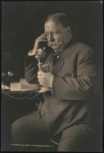 William Howard Taft, three-quarter-length portrait, seated, facing left, talking on a telephone as he receives news about his nomination as the 1908 Republican presidential candidate from LCCN2015647021