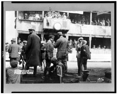 William Kissam Vanderbilt, II, full-length, standing on track for automobile race, facing right, with crowd in grandstand in background LCCN94507273