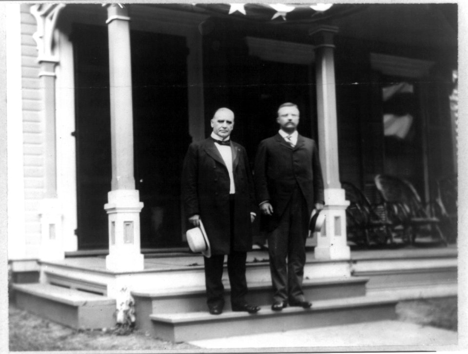 William McKinley and Theodore Roosevelt standing on step of porch LCCN96512190
