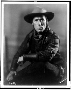 William S. Hart, three-quarter length portrait, seated, facing front, in cowboy outfit LCCN91738537