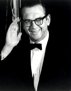 Willis Conover waves to fans