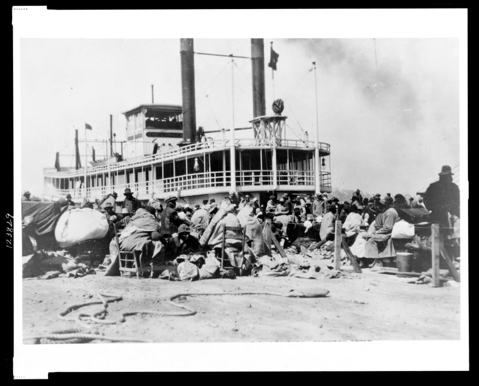 With all their worldly goods-Wrapped in blankets, carrying their most prized possessions, the patient colored folk wait for the Red Cross to rescue them from the levee LCCN99471518