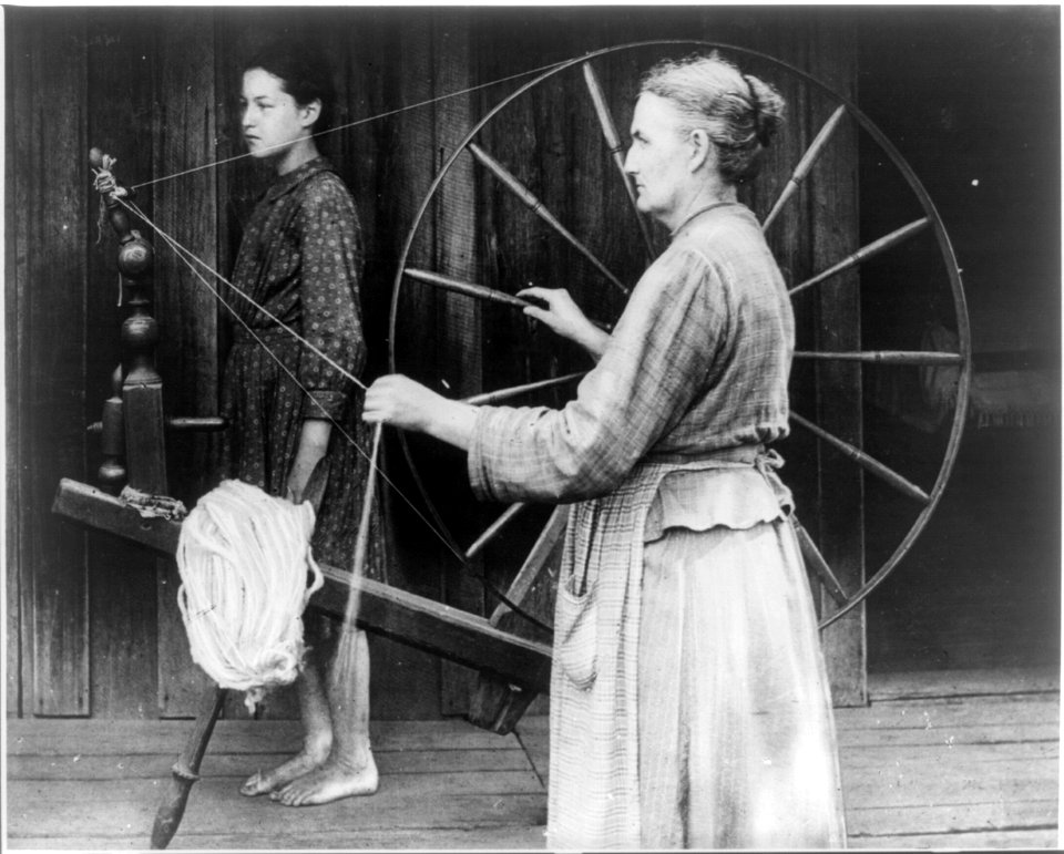 Woman at spinning wheel, young girl in background LCCN2013646076
