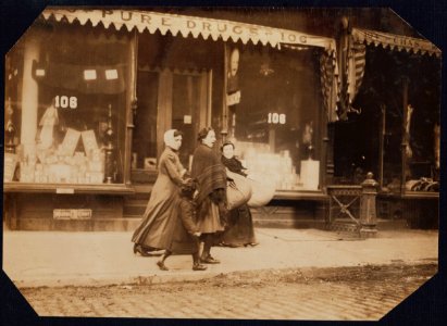 Woman and girl carrying finished couset covers made on Macdougal St.-to factory-171 Wooster Street, N.Y. LOC cph.3b01124