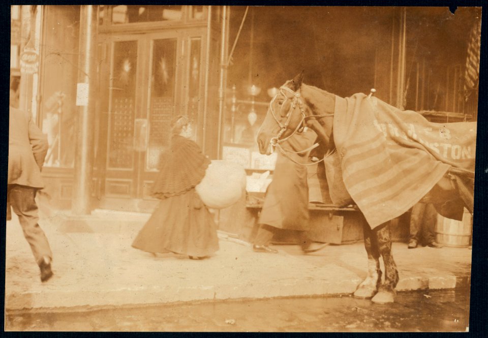Woman carrying corset covers made on Macdougal St. to factory, 171 Wooster Street, N.Y. LOC nclc.04170