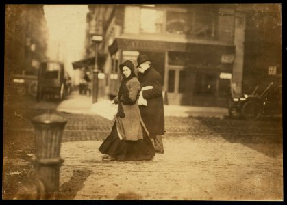 Woman carrying flowers home, W. Houston St., N.Y. A short time ago she told me they were not going to make flowers any more. LOC cph.3b01102