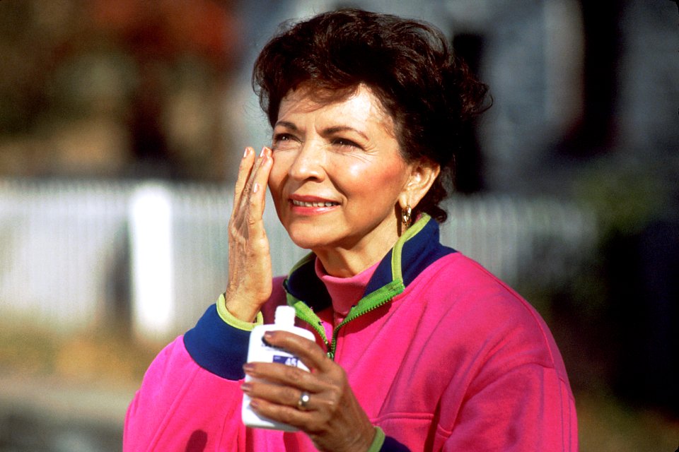 Woman applying sunscreen