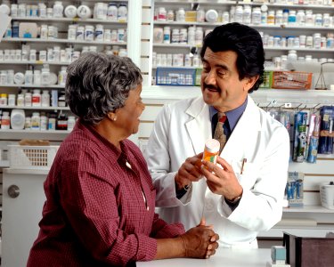 Woman consults with pharmacist photo