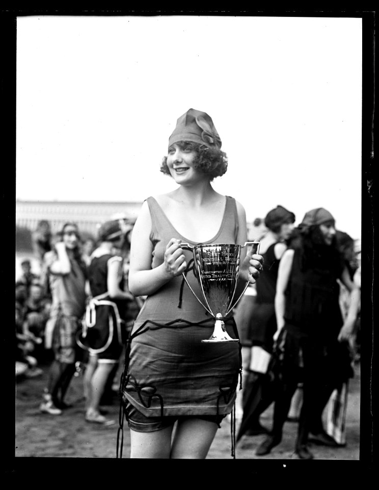 Woman in bathing suit with first prize cup LCCN2016891480