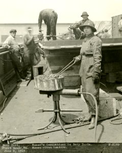 Woman heating rivets