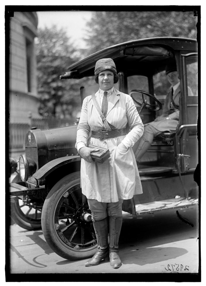 Woman in uniform wearing hat with label- 'War Camp Community Service' LOC hec.11267