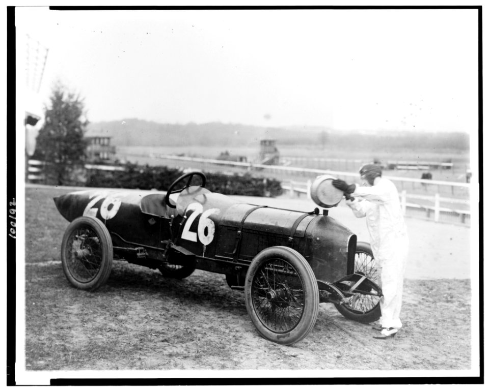 Woman putting water in radiator of Stutz Weightman Special no 26. on Benning race track, Washington, D.C., area LCCN90710634