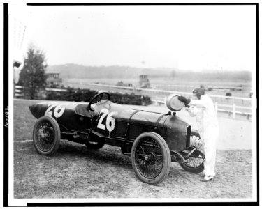 Woman putting water in radiator of Stutz Weightman Special no 26. on Benning race track, Washington, D.C., area LCCN90710634