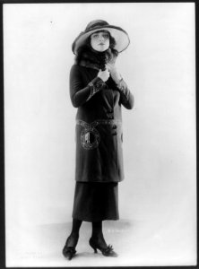 Woman modeling hat and suit with long coat and fur collar LCCN2003678052