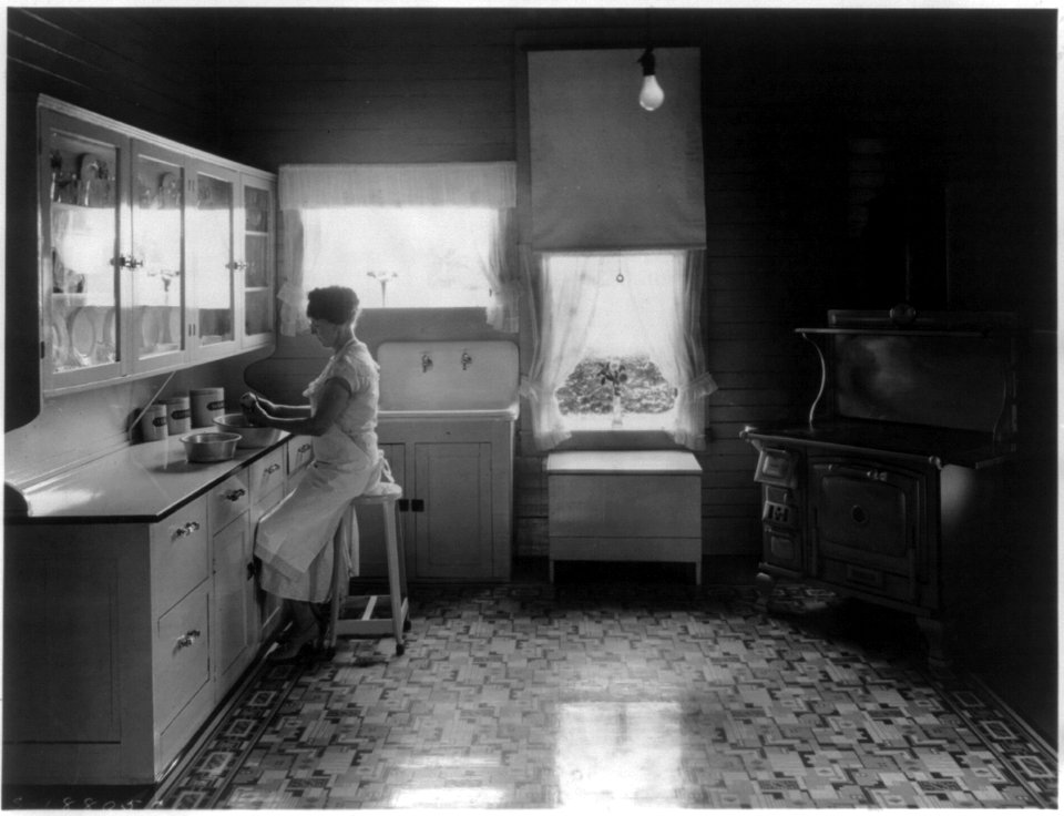 Woman peeling potatoes in modern farm kitchen LCCN2004679600