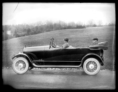 Woman driving automobile with man seated in back LCCN2016824447 photo