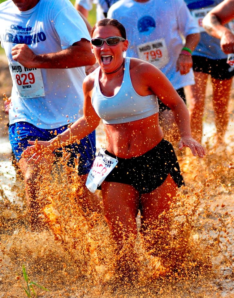 Woman runs through mud