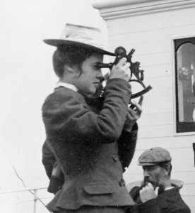 Woman looking through sextant on board the expedition vessel George W. Elder