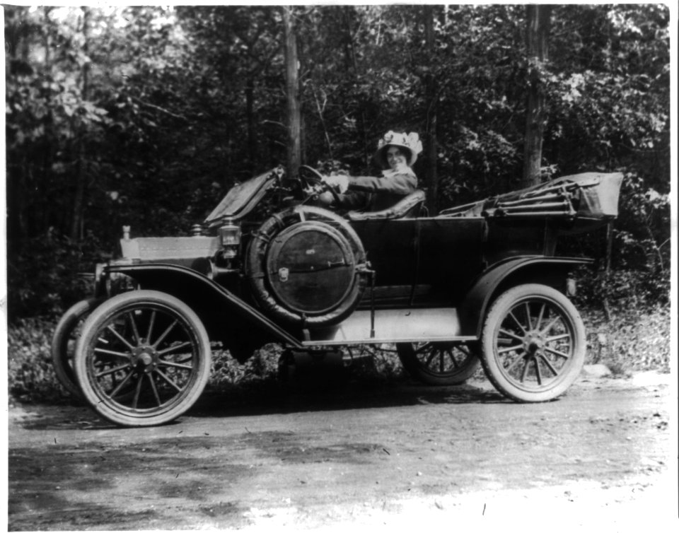 Woman seated behind steering wheel of automobile LCCN2001706316