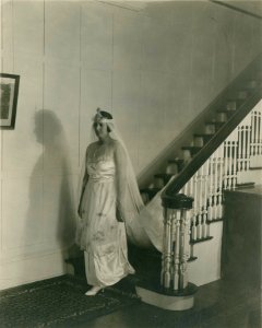 Woman in bridal gown descending staircase, Illinois, early 20th century (NBY 696)