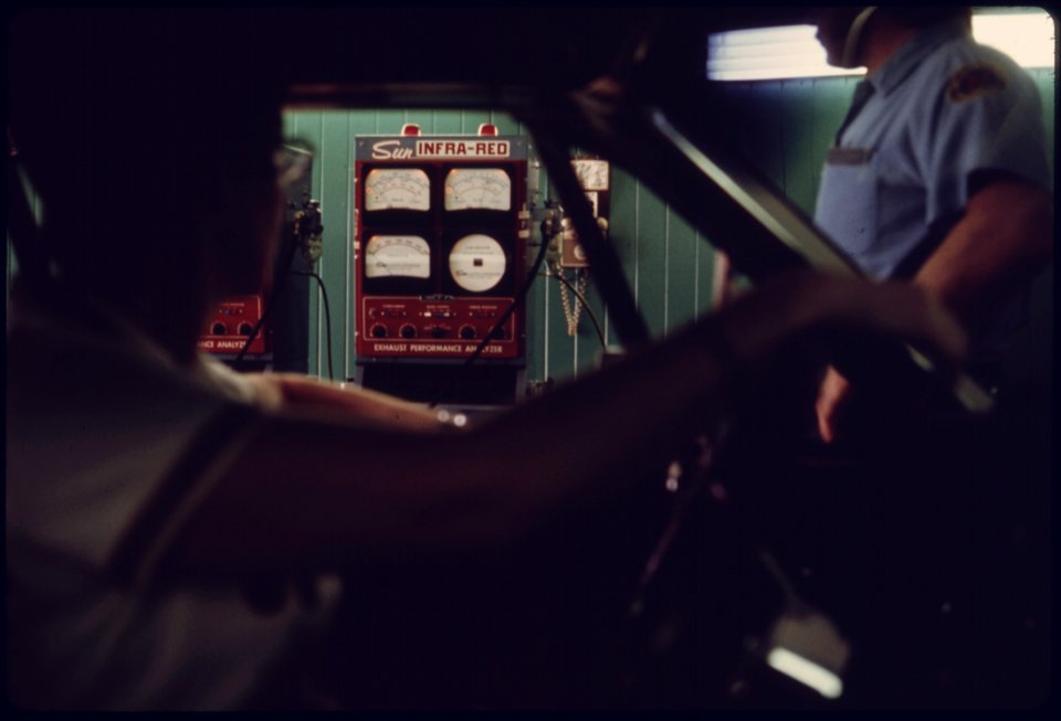 Woman Sits in Her Car Watching the Readings on the Exhaust Analyzer in an Auto Emission Inspection Station in Norwood, Ohio Her Auto Was Being Retested after Failing the First Time It Was Inspected. 08-1975 (4265782371)