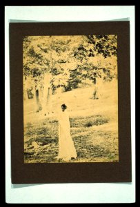 Woman standing in a park, trees in background) - EW LCCN2004676346 photo