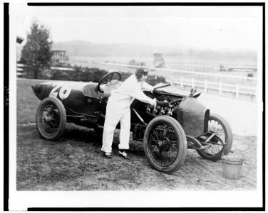 Woman working under hood of Stutz Weightman Special no. 26 on Benning race track, Washington, D.C., area LCCN90710636