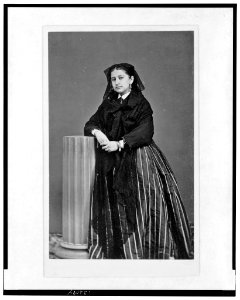 Woman wearing shawl, full-length portrait, standing facing front, with arm propped on half column LCCN2005692515