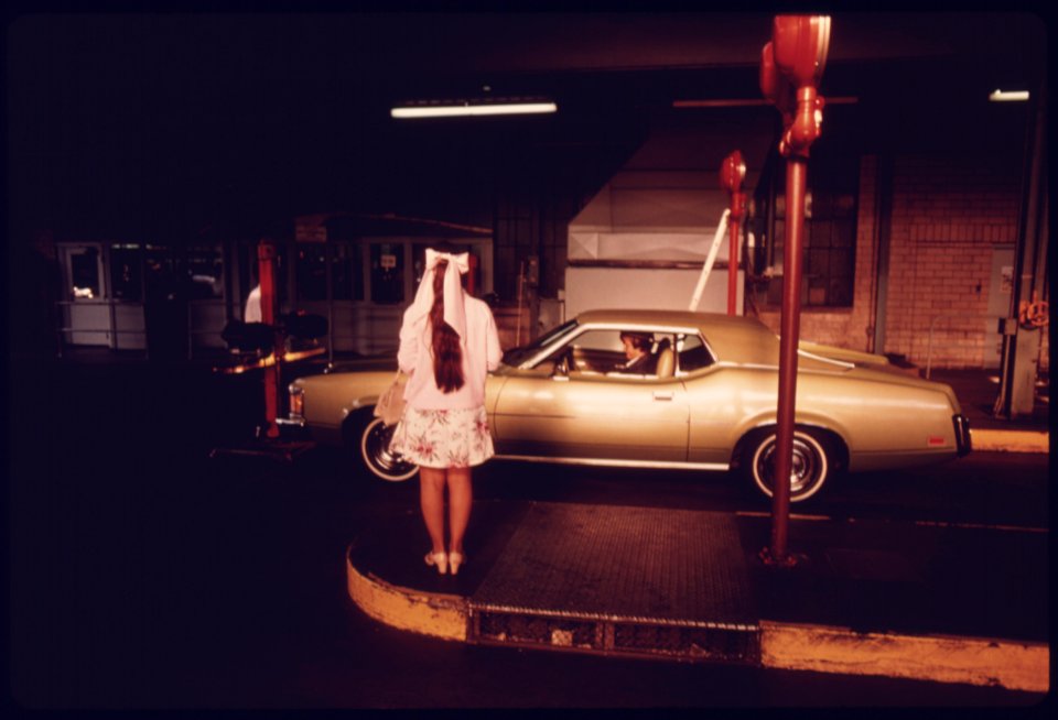 Woman Waits for Her Car to Complete Testing at an Auto Emission Inspection Station in Downtown Cincinnati, Ohio...09-1975 (4265794503)