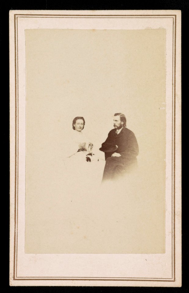 Woman with cat on her lap and handiwork, man holding hat) - J. G. Stacy, Dover, Me LCCN2016653161