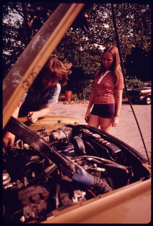 Woman Watches as Minor Adjustments Were Made to Her Auto's Carburetor During Retesting after Her Vehicle Had Failed at an Auto Emission Inspection Station in Downtown Cincinnati, Ohio...09-1975 (4266542458)