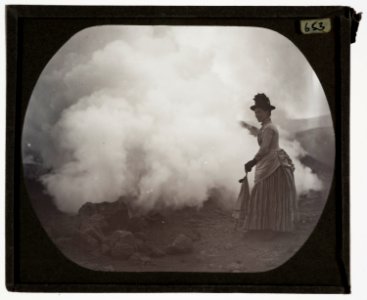 Woman with parasol looking over edge into crater YORYM TA653