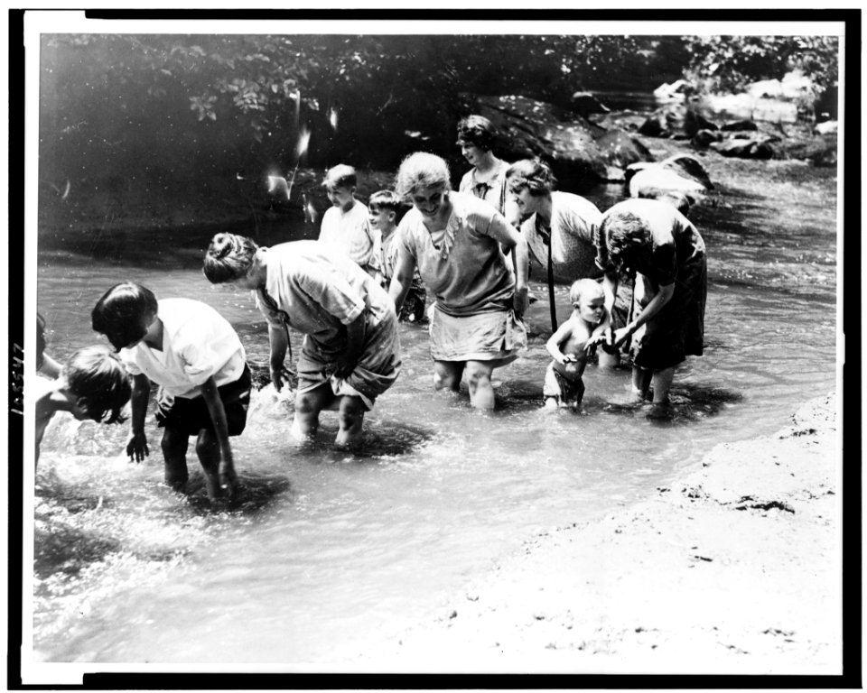 Women and children find some relief by wading in the creek on one of the hottest days in the history of the Capital. Snapped in Rock Creek Park today LCCN92513239