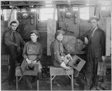 Women electric welders at Hog Island shipyard. These are the first women to be engaged in actual ship construction, in t - NARA - 533763 photo