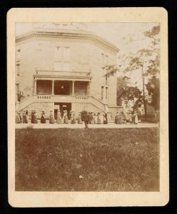 Women walking in a procession, pulling a wheelchair LCCN2015645627