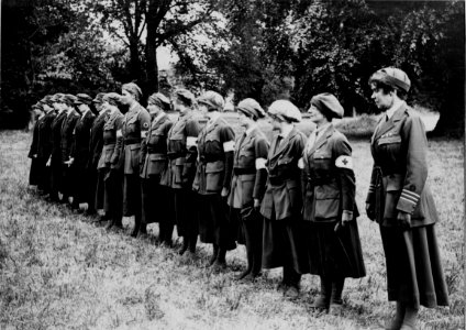 Women ambulance drivers lined up to receive decorations. Blendecques 165-BO-0103