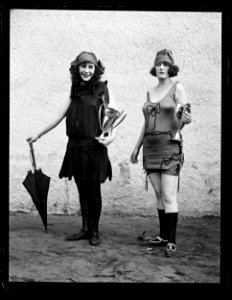 Women in bathing suit with prize cups LCCN2016891482