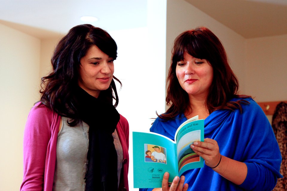 Women look over publication (1)